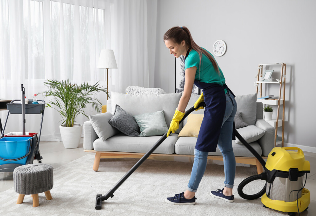 cleaning lady vacumming the carpet
